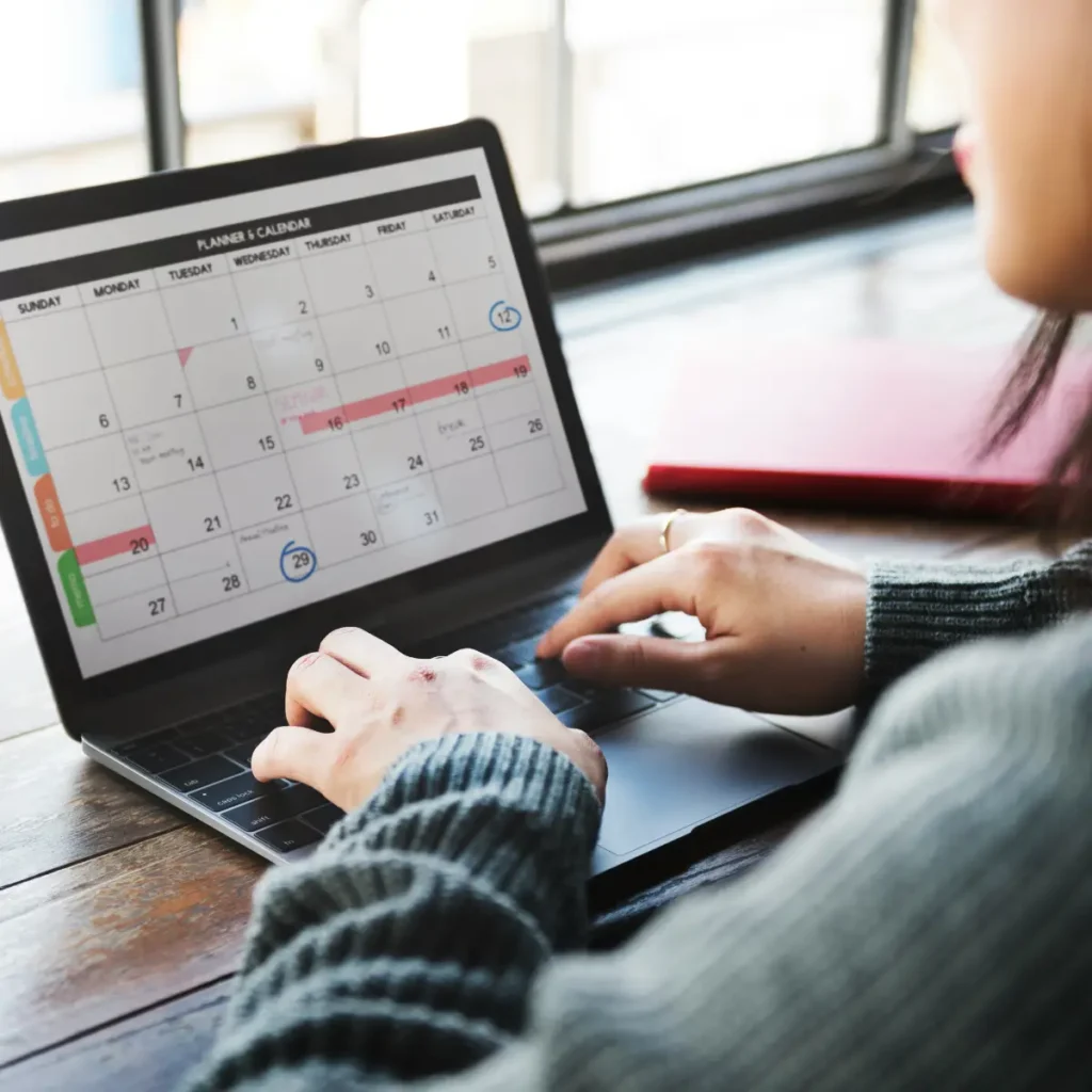 woman editing her calendar on her laptop