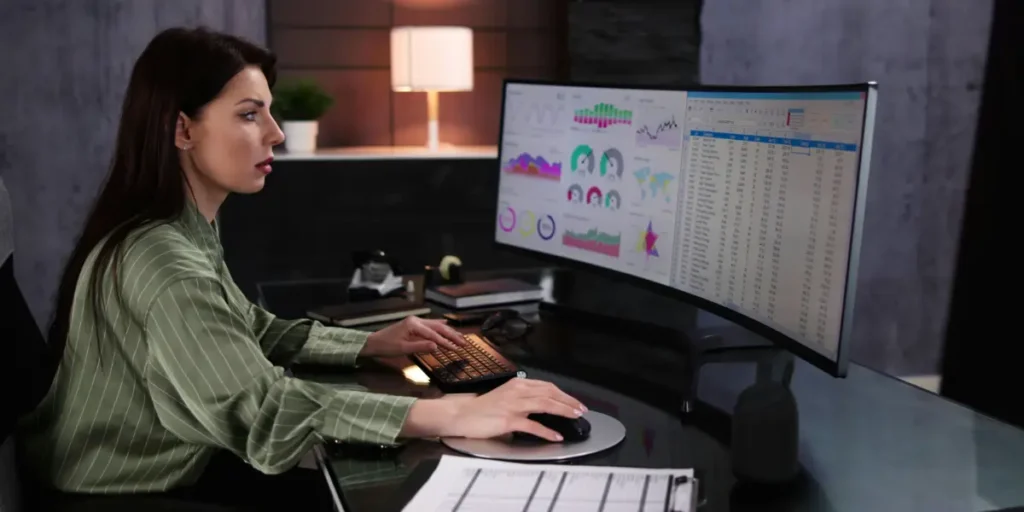 woman analyzing financial data, spreadsheets on her computer